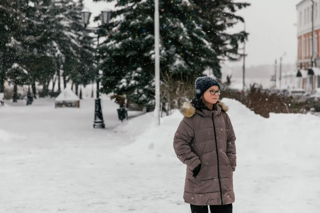 girl with seasonal depression walking in snow