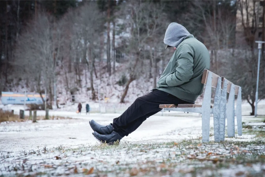 Person walking alone on a cloudy winter day in Canada, symbolizing seasonal depression (SAD)