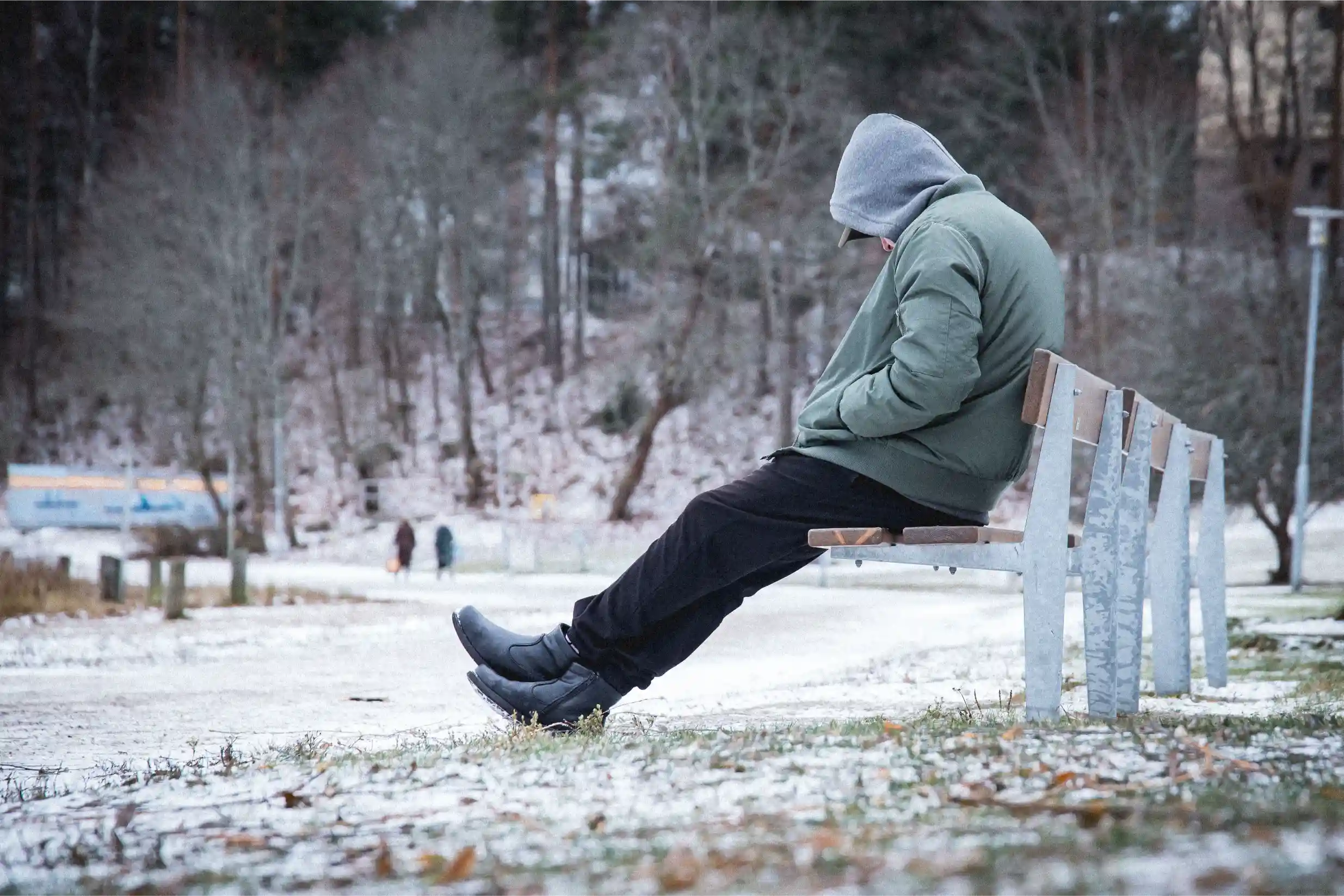 Person walking alone on a cloudy winter day in Canada, symbolizing seasonal depression (SAD)