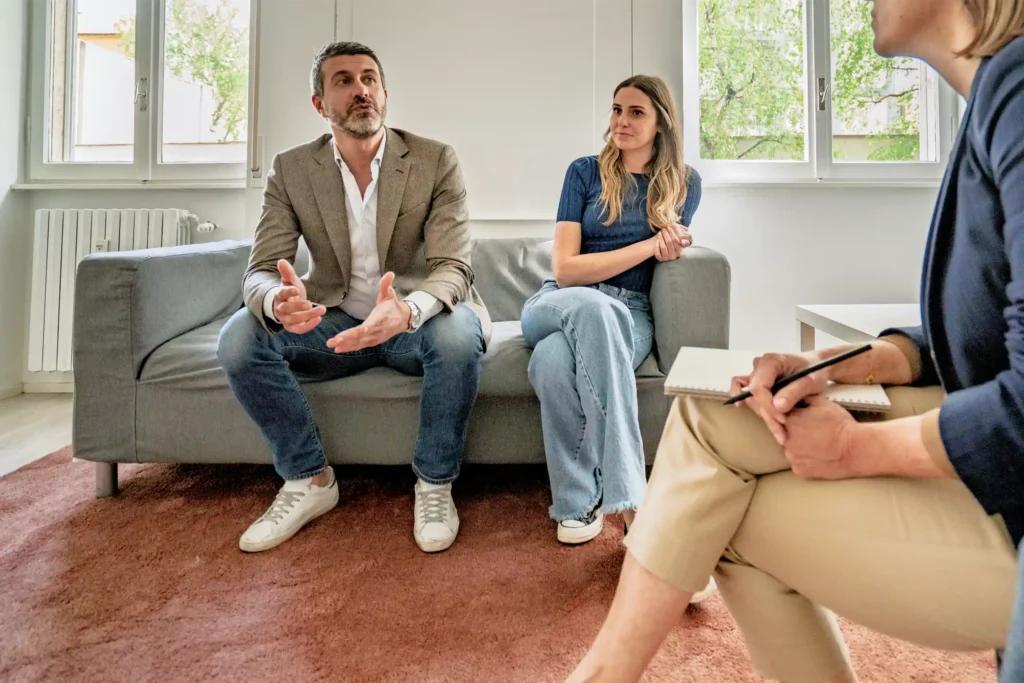 Therapist guiding a couple through a discussion during a session